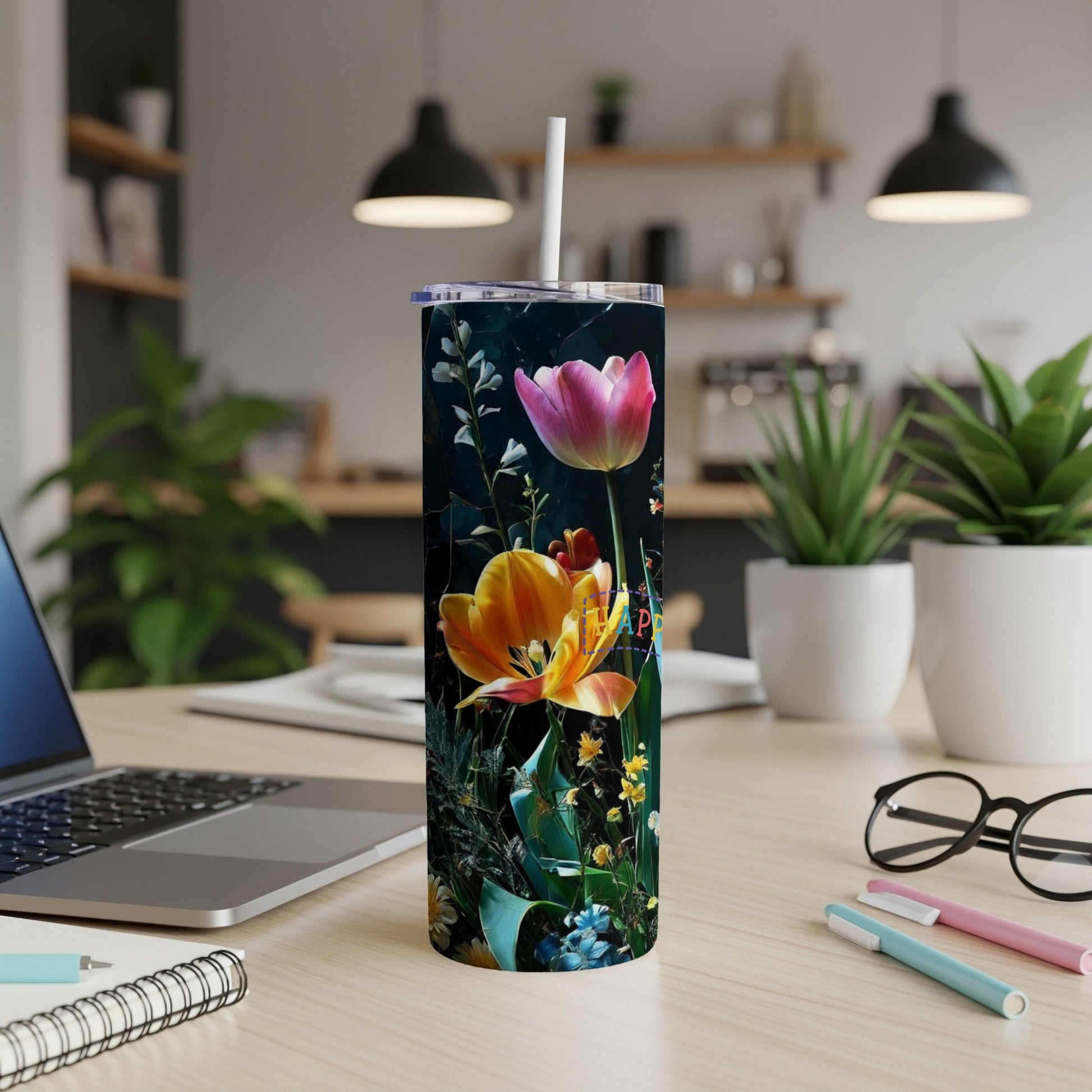 Tall tumbler with bright pink and orange tulips against dark floral background.
