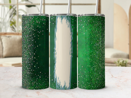 Three green speckled tumblers with straws on a marble surface.