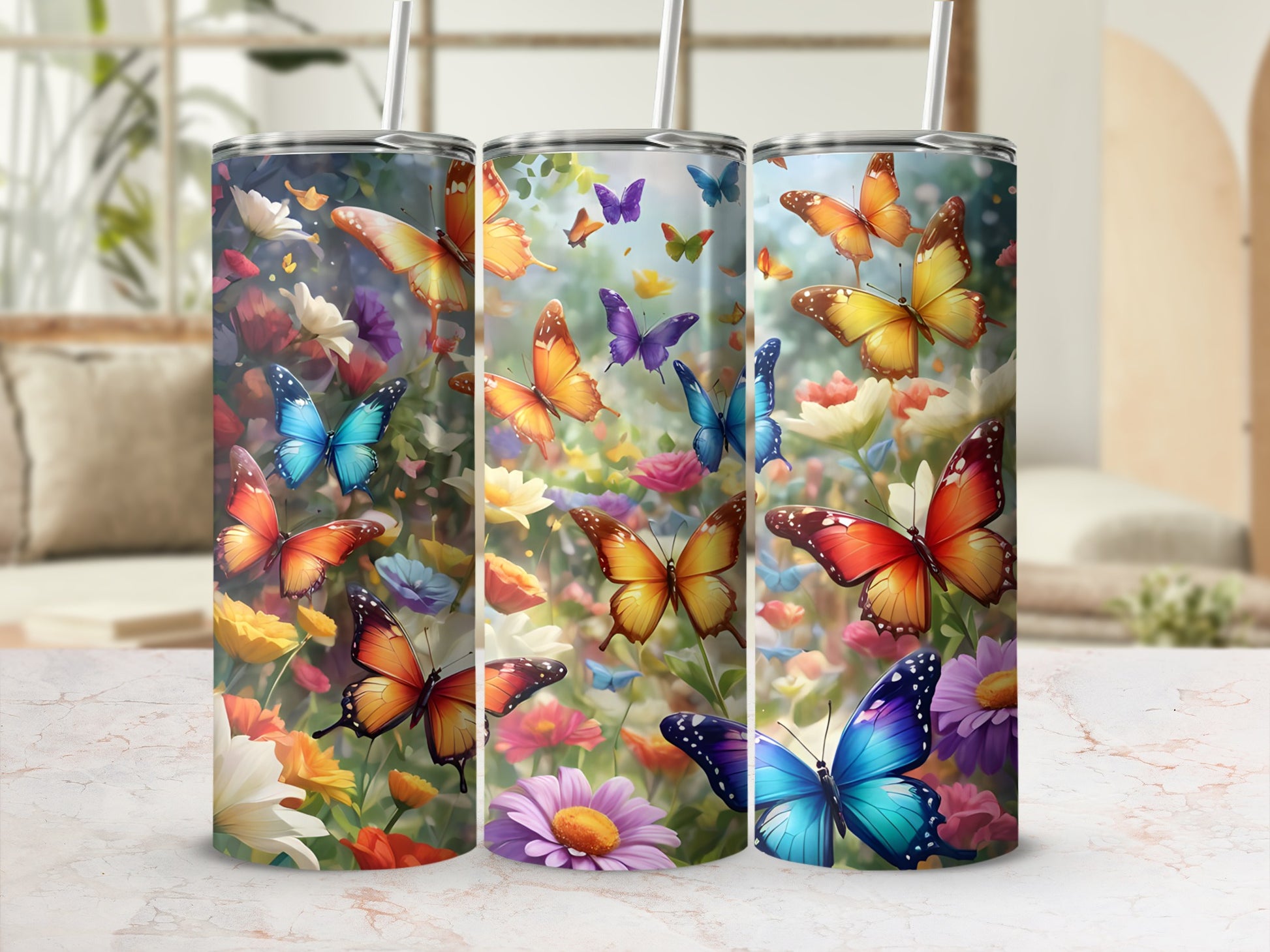 Three tumblers with colorful butterflies and flowers.