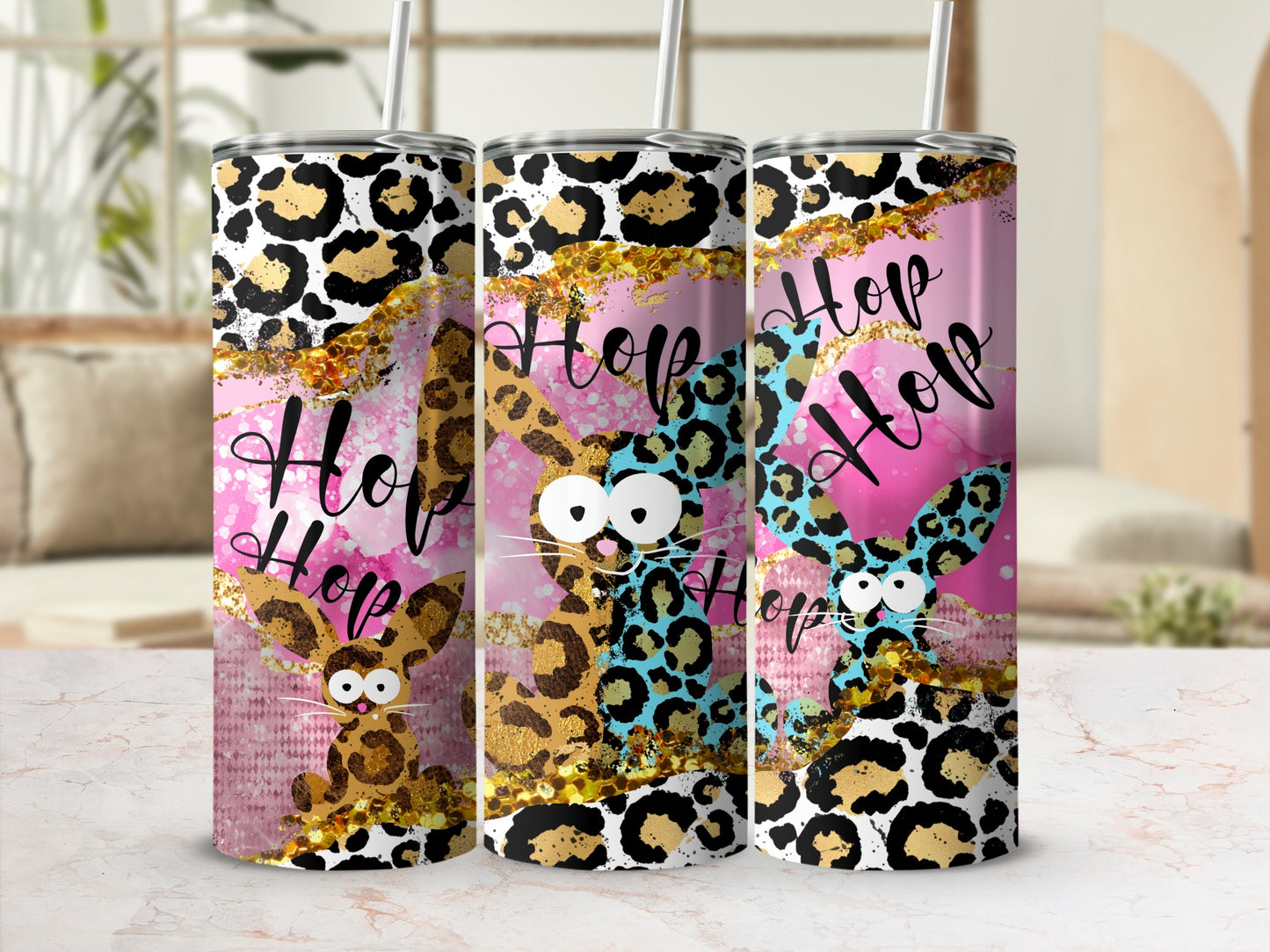Three leopard print tumblers with "Hop Hop" text and bunny ears.
