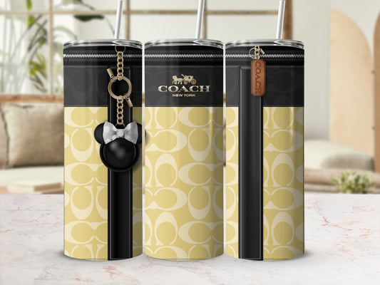 Coach tumbler with tan signature C pattern and Mickey Mouse charm.
