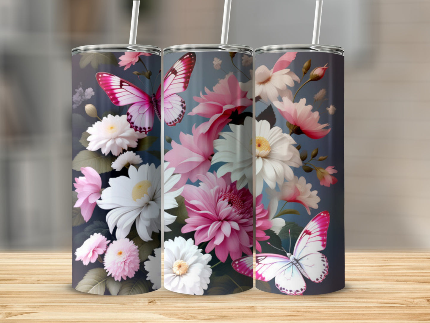 Floral and butterfly design on a set of three tall tumblers.