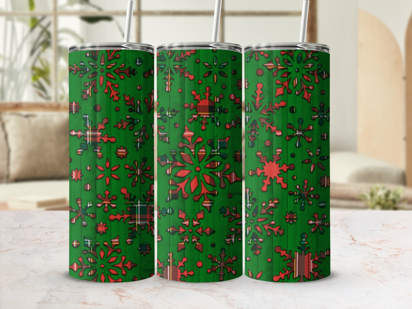 Green tumbler with red snowflakes and plaid pattern.