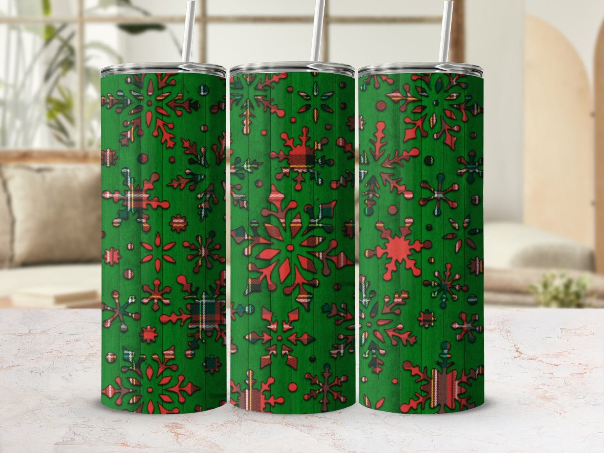 Green tumbler with red snowflakes and plaid pattern.
