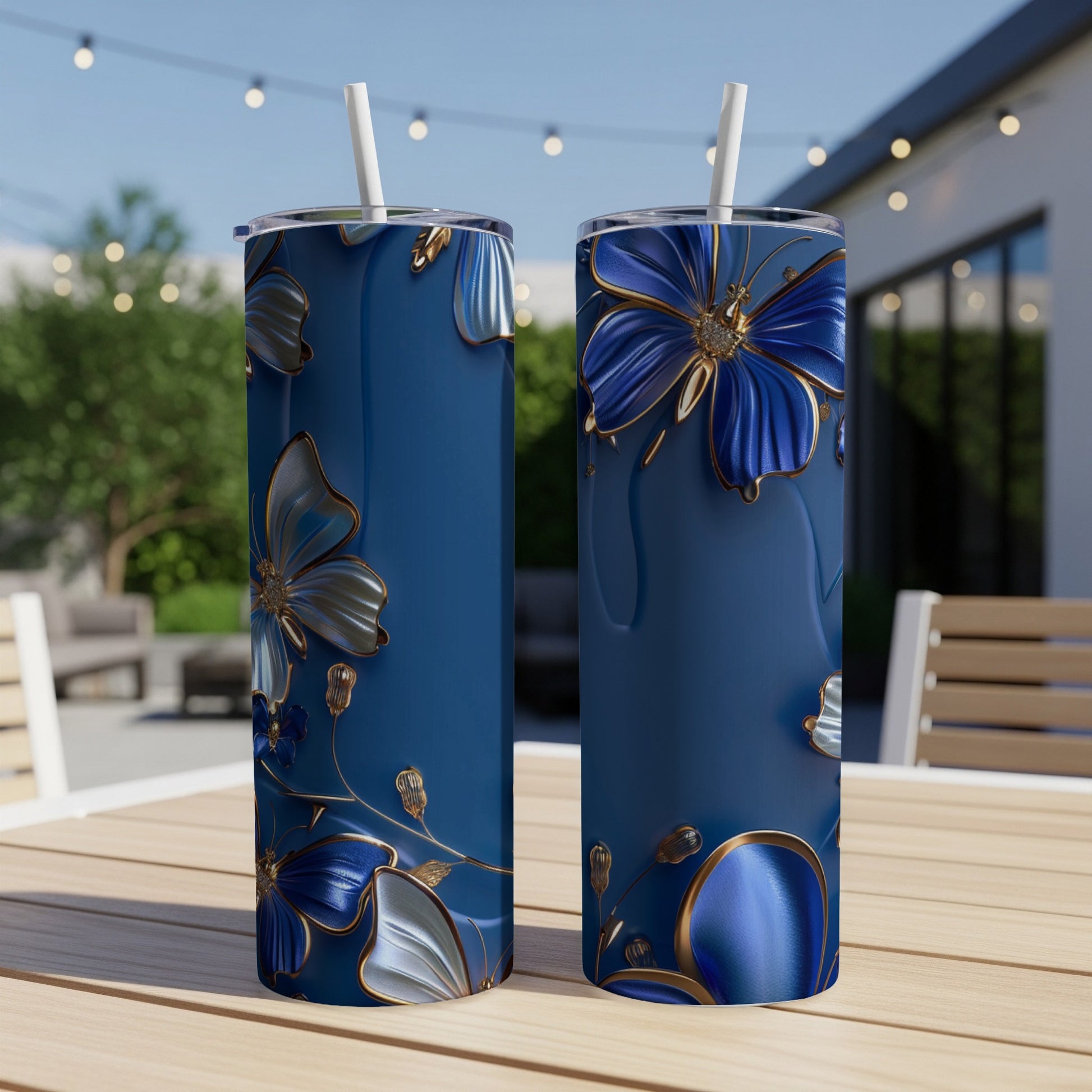 Two tall, blue tumblers with intricate gold and blue floral designs.