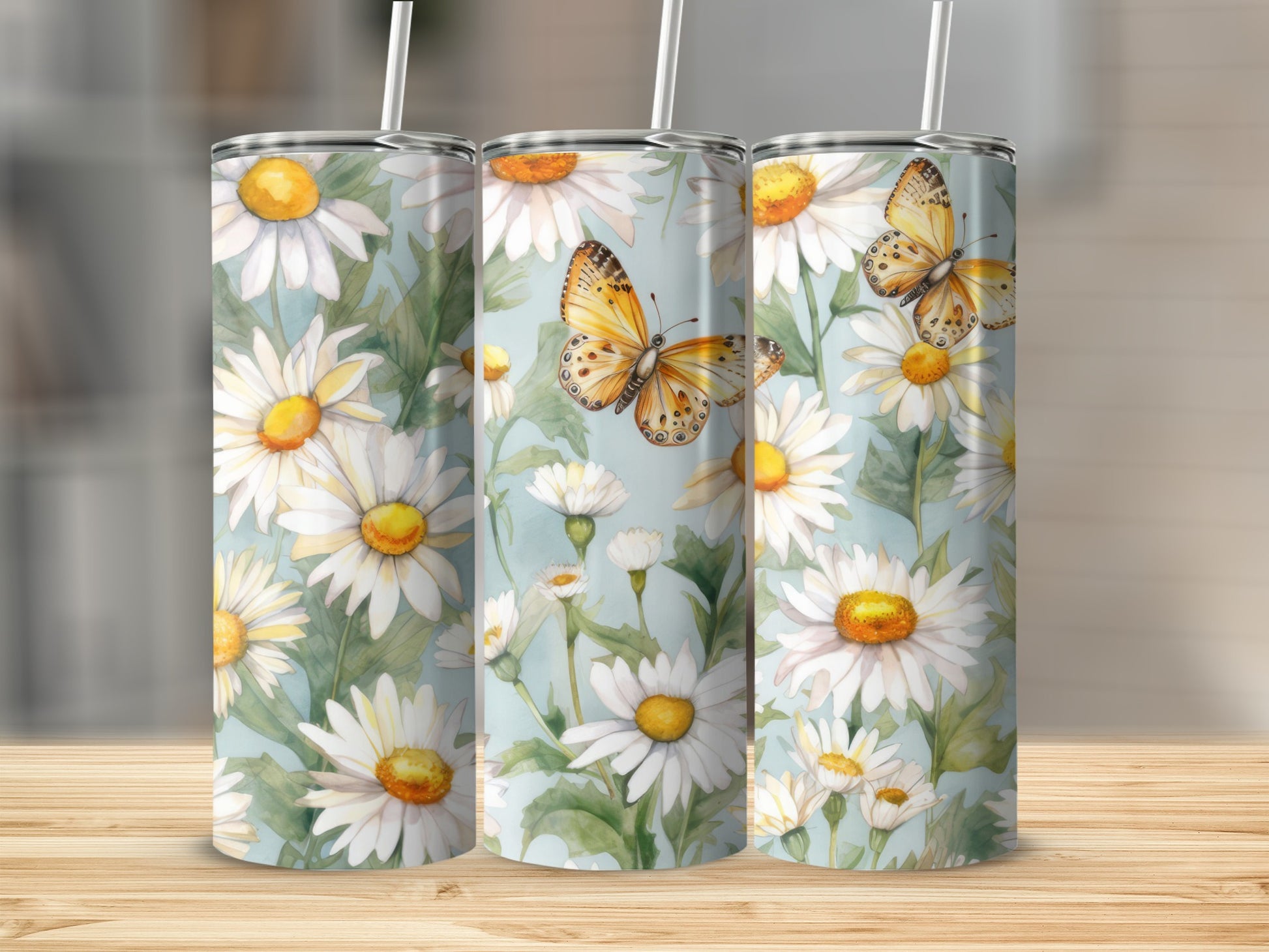Three tumblers with a daisy and butterfly design.