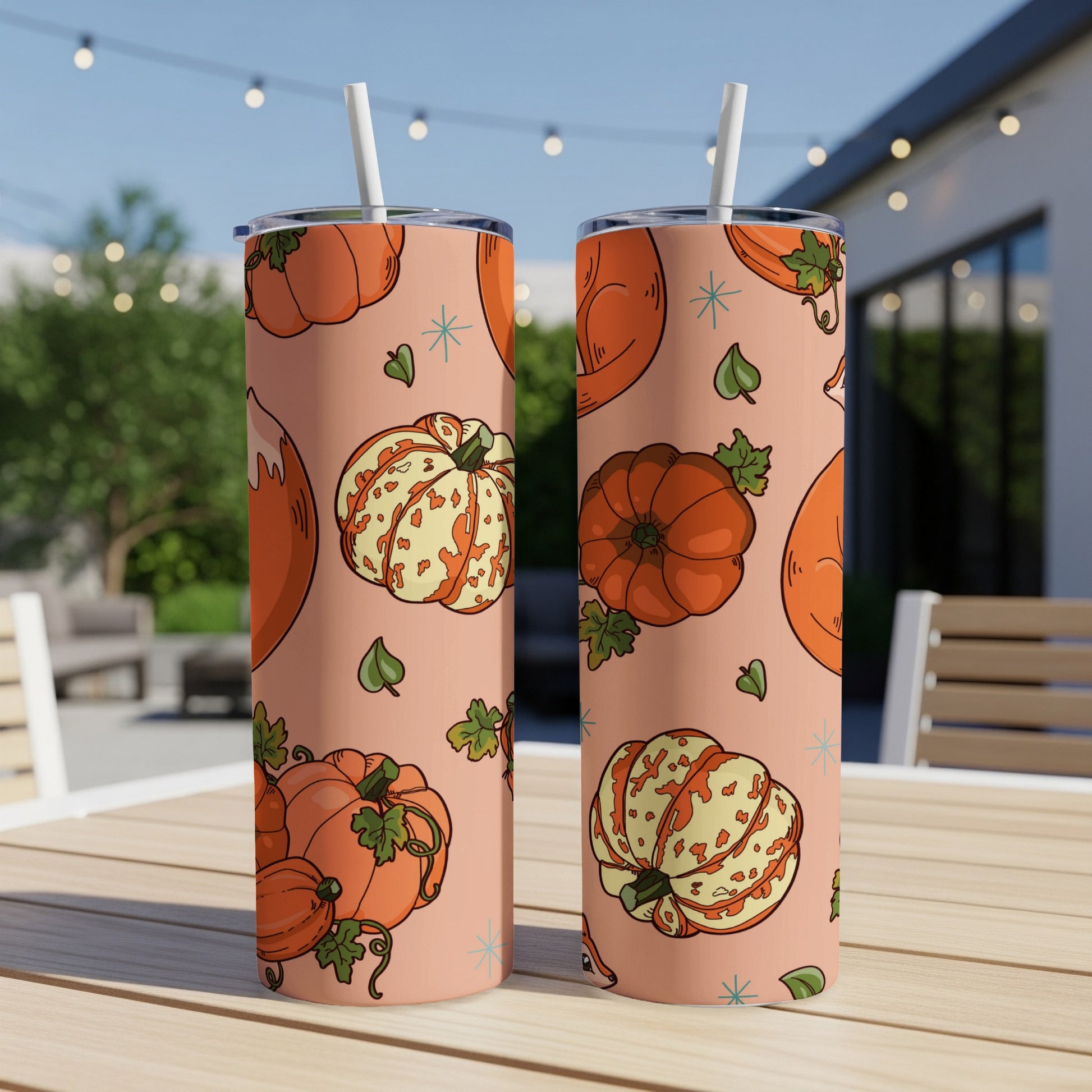 Two tumblers with a pink background featuring a pumpkin and leaf pattern.