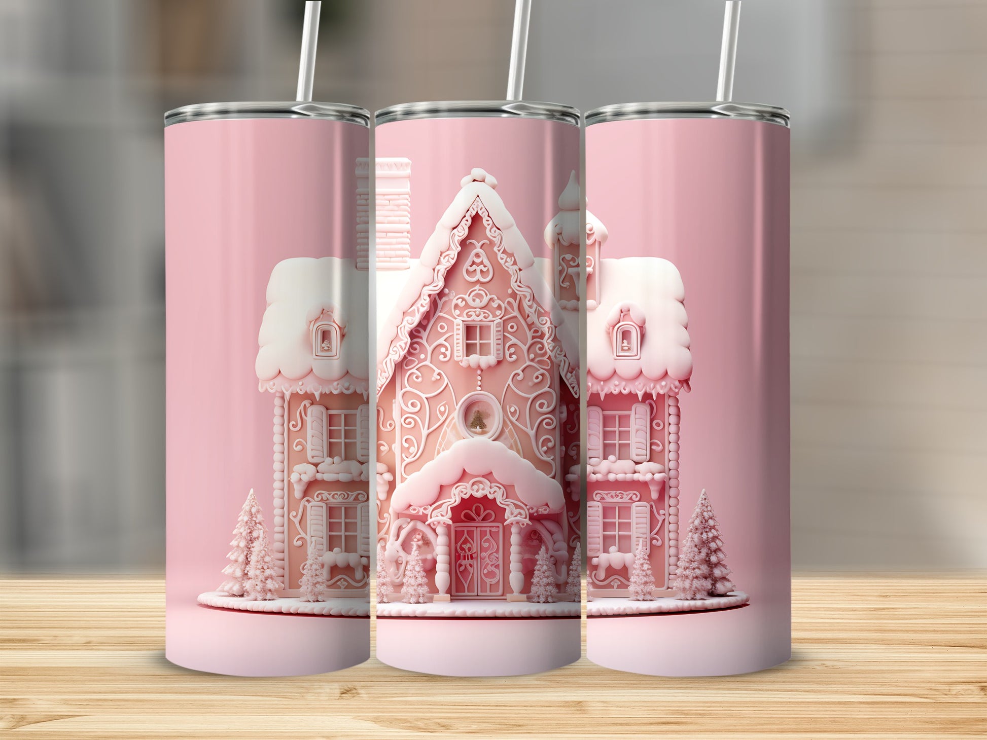 Three pink gingerbread house tumblers with lids and straws.