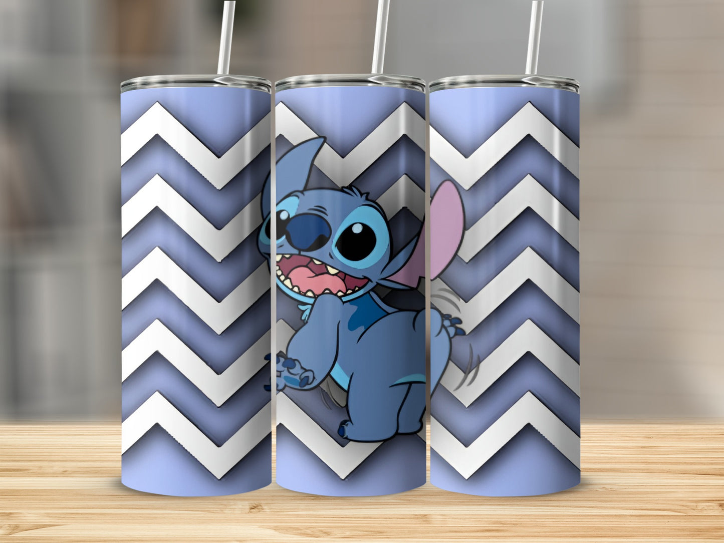 Three blue tumblers with a cartoon Stitch character and white chevron pattern.