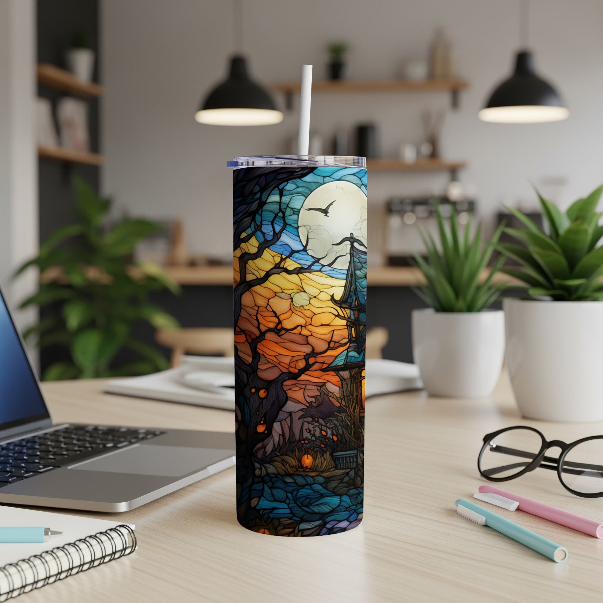 Halloween stained glass art on a tall, slender tumbler with straw.