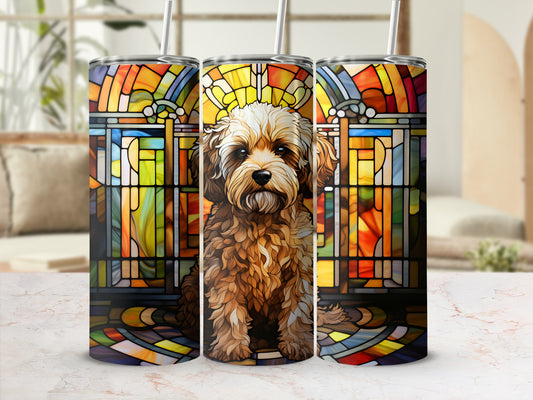 Shaggy dog sits before stained glass window design on a tumbler.