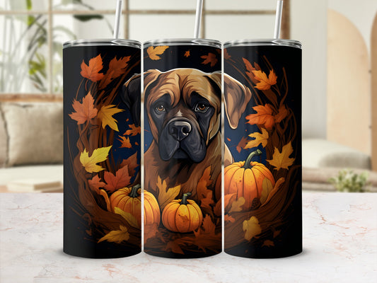 Bullmastiff dog with pumpkins and autumn leaves on a black tumbler.