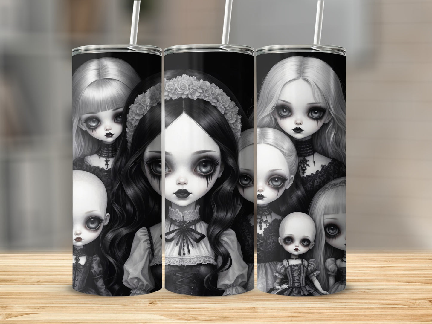 Collection of gothic dolls with pale skin and dark hair on a wooden surface.