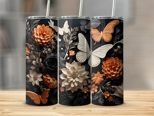 Three tumblers with floral and butterfly designs on a wooden surface.