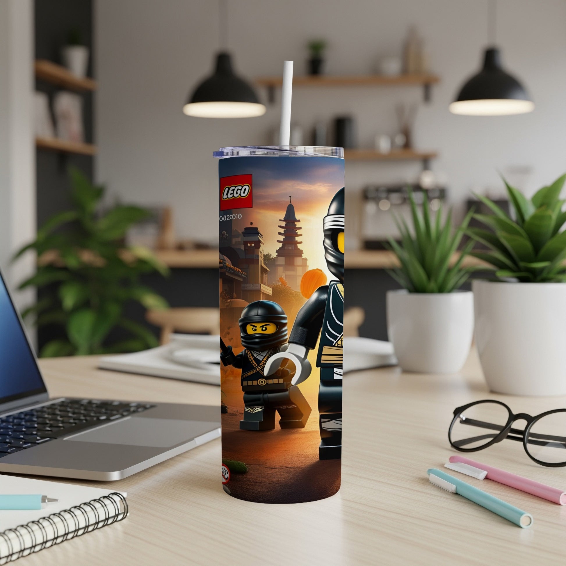 Lego Ninjago characters on a tumbler with a straw on a desk.