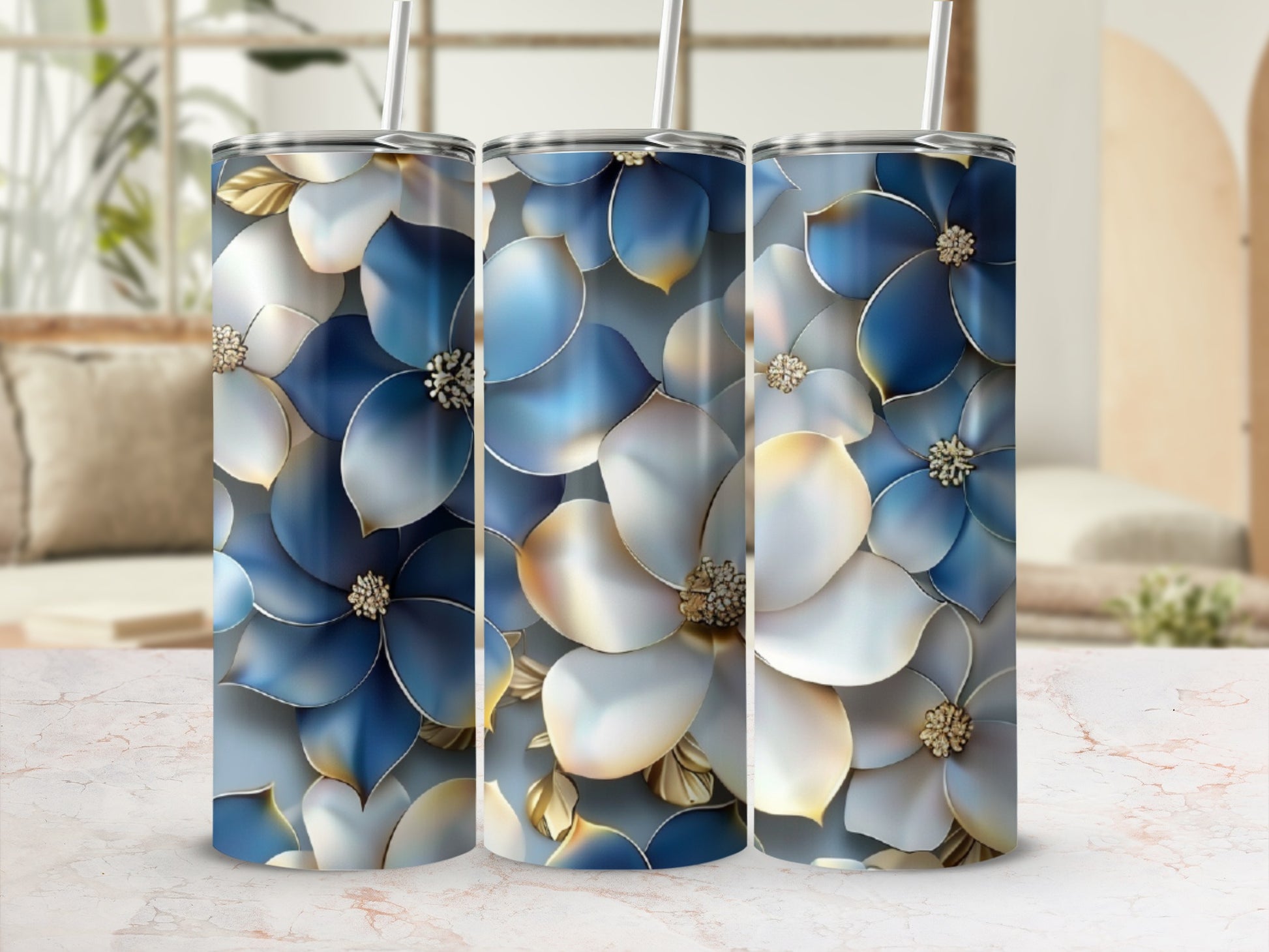 Three tumblers with blue and white floral patterns and gold accents.