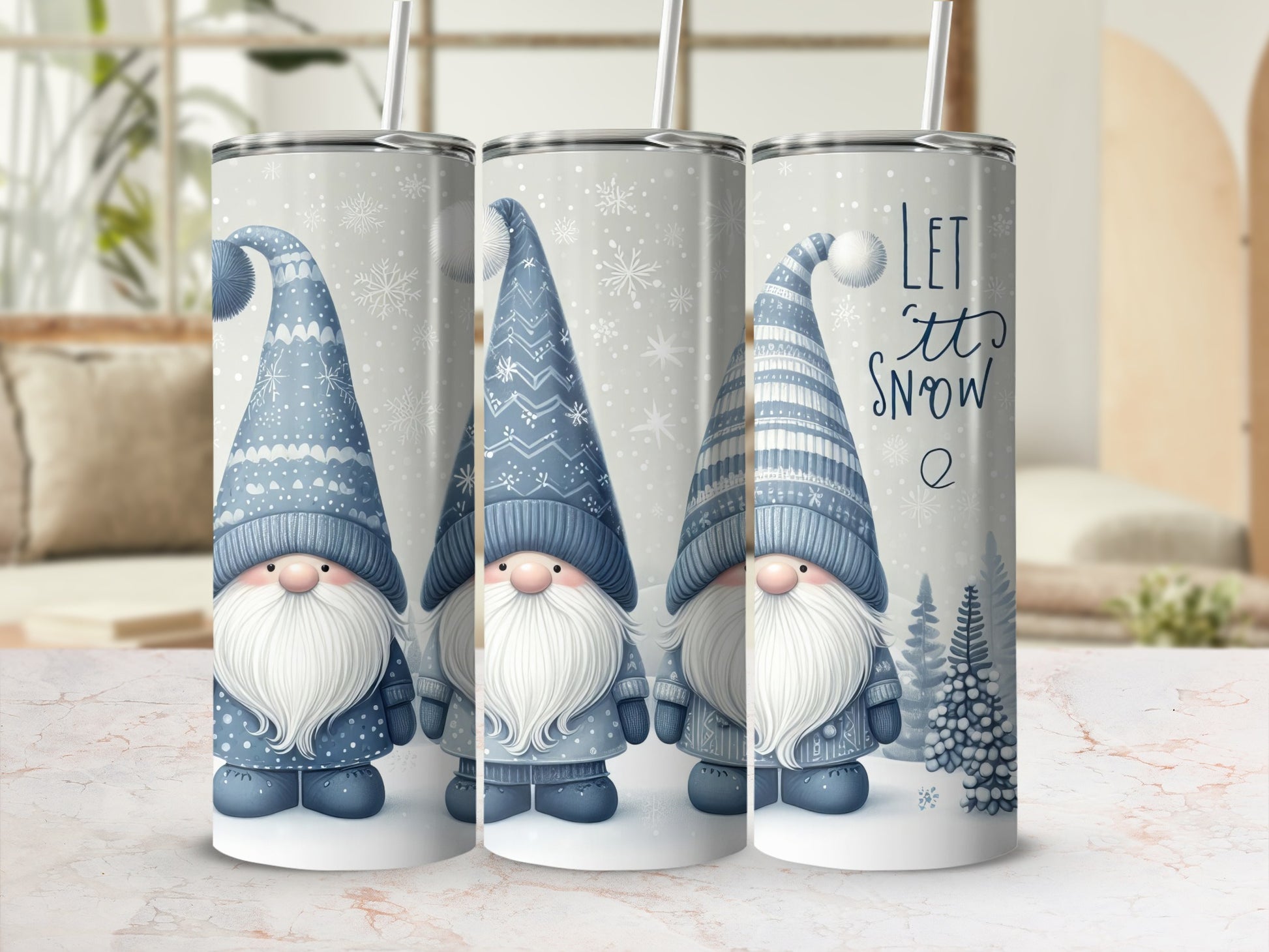 Three tumblers with gnome and snowflake Christmas designs.
