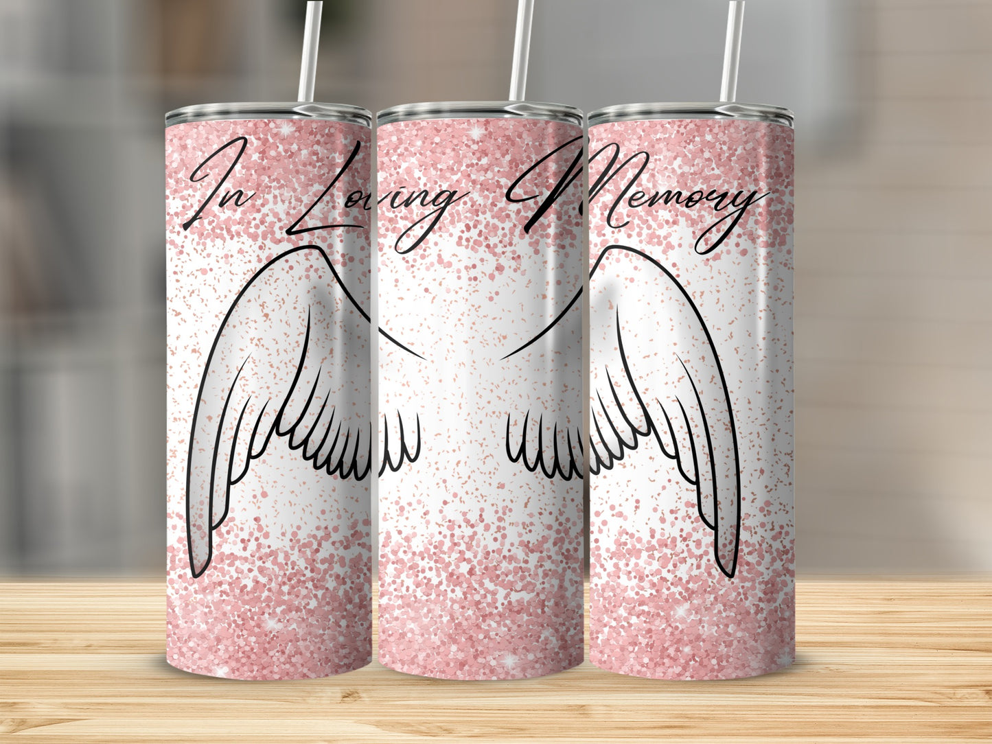 Angel wings and glitter design on three insulated tumblers.