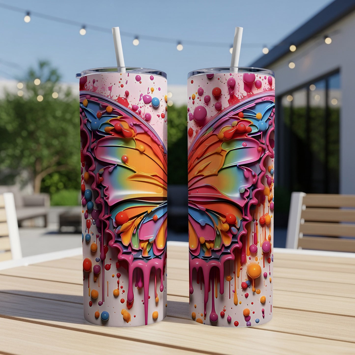 Colorful butterfly wings on two tumblers with dripping paint effect.