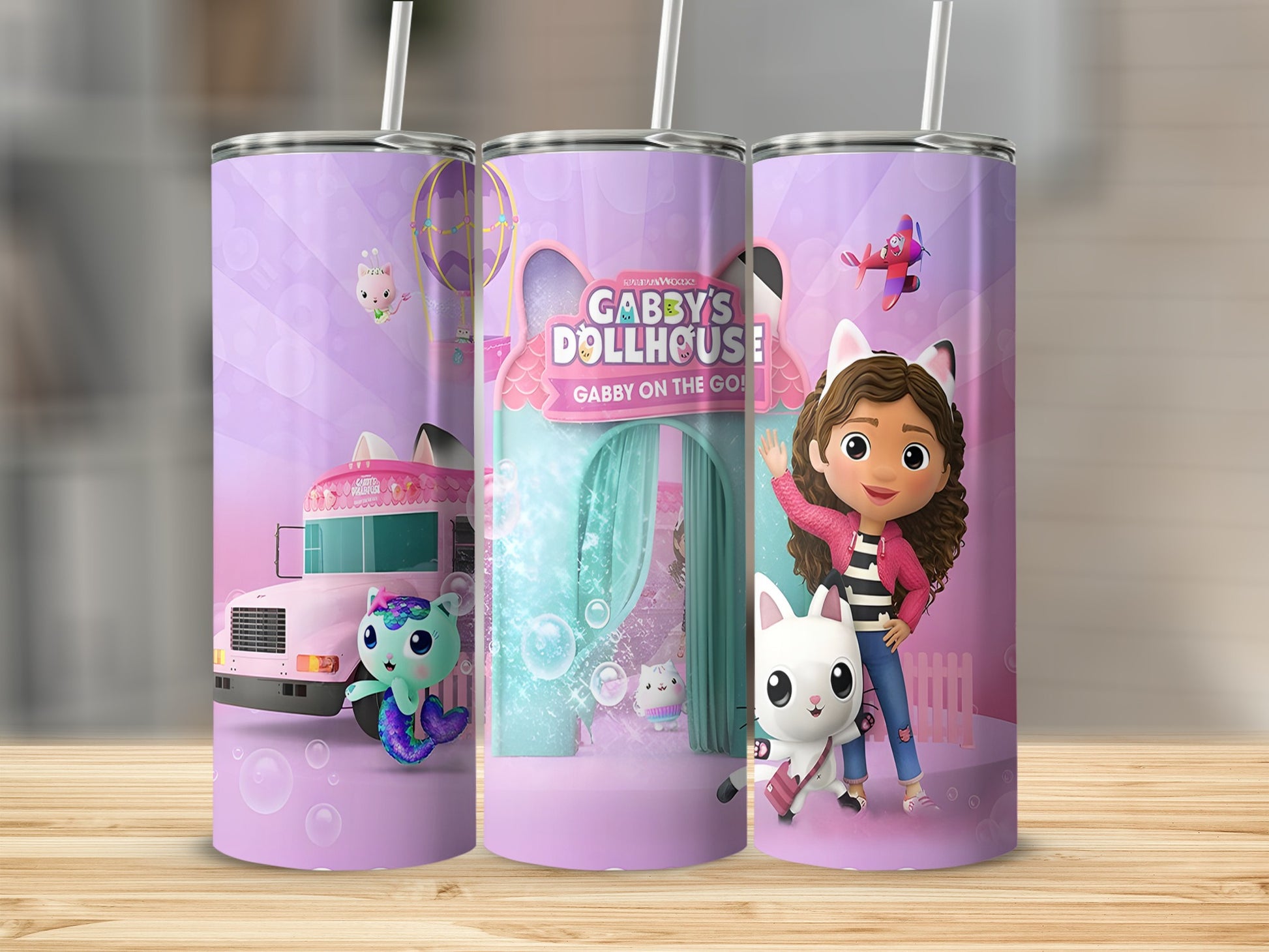 Gabby's Dollhouse tumbler with Gabby, Pandy, and vehicles on a purple background.