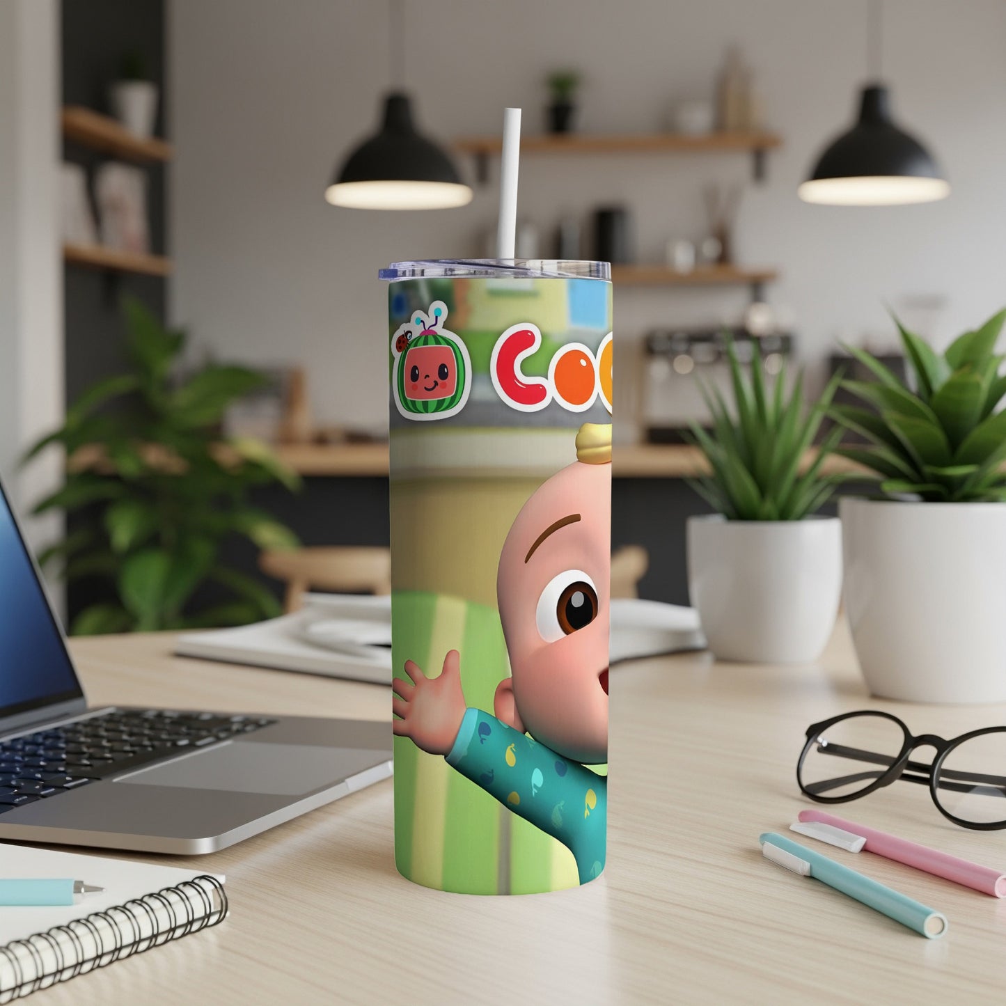 CoComelon character waving on a green striped tumbler with a straw.