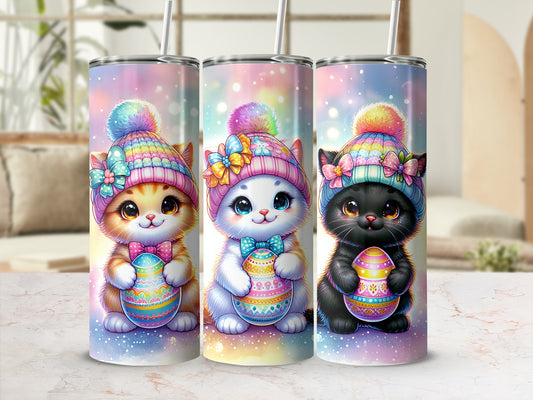 Three kittens in colorful Easter bonnets hold decorated Easter eggs.