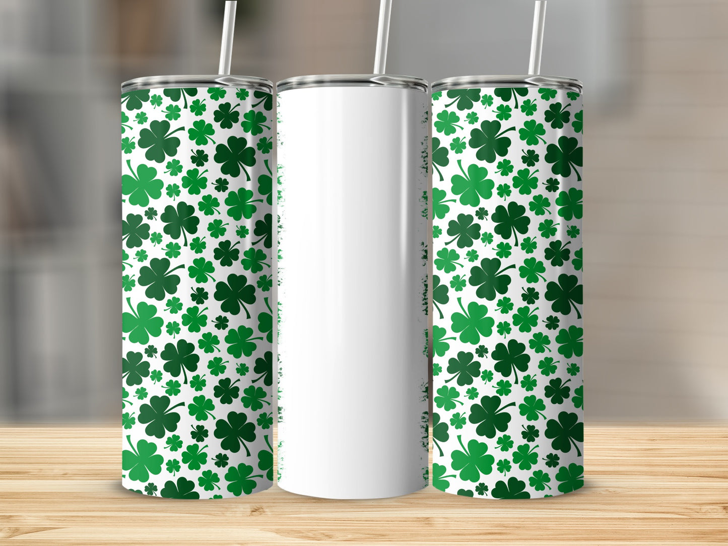 White tumbler with repeating green shamrock pattern and straw.