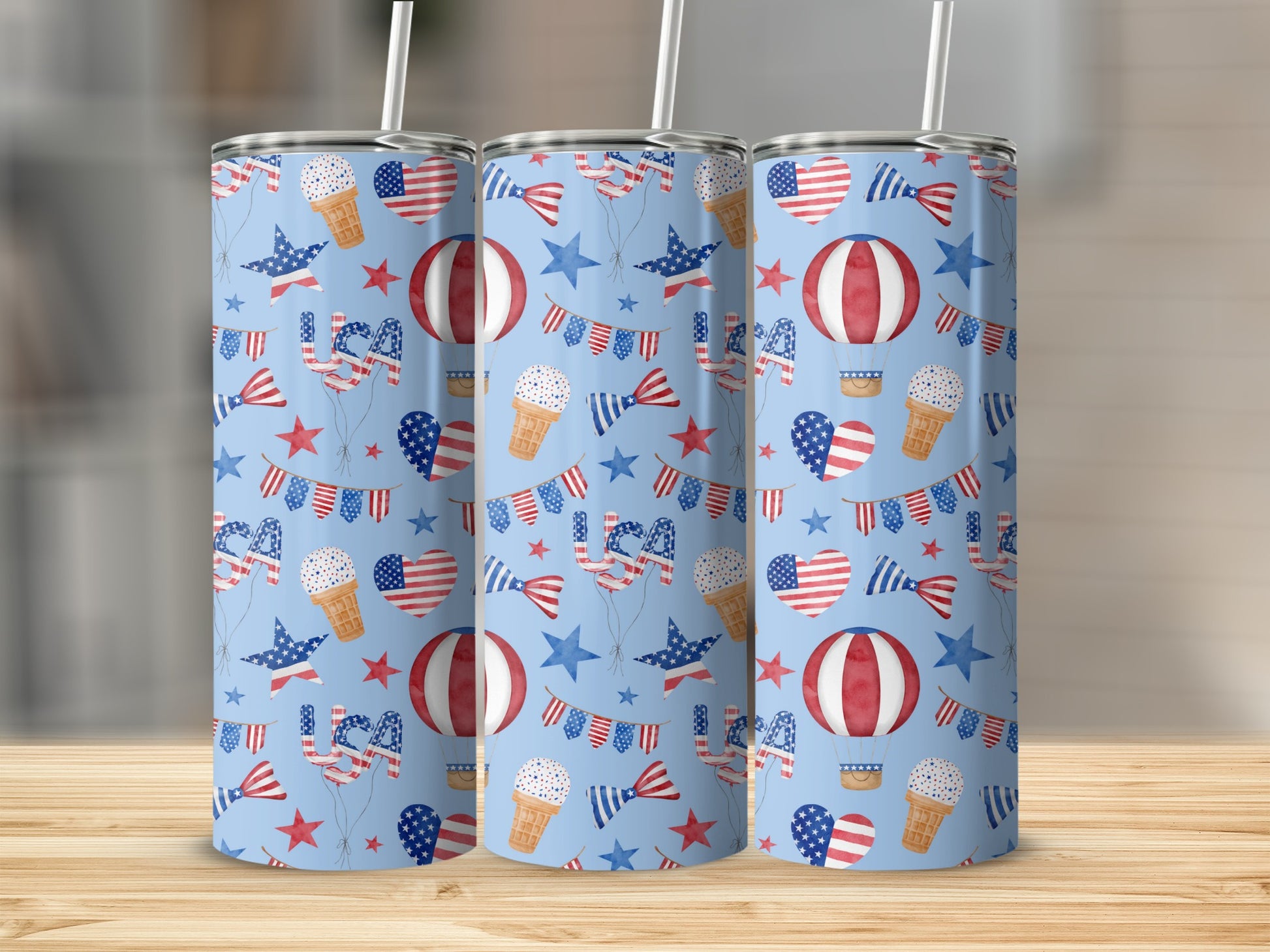 Blue tumbler with repeating pattern of American flags, hot air balloons, and stars.