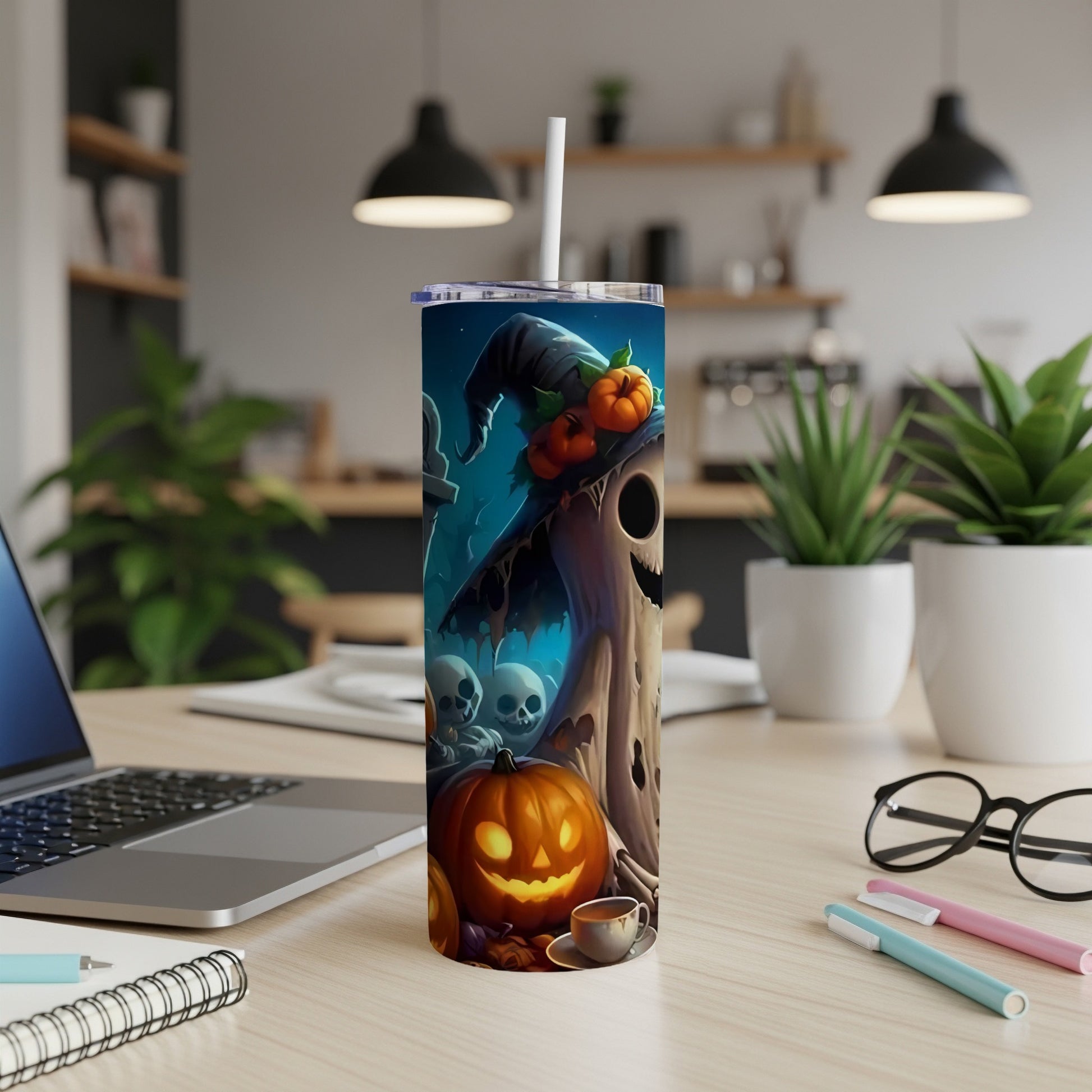 Halloween tumbler with ghost, pumpkins, and skulls design.