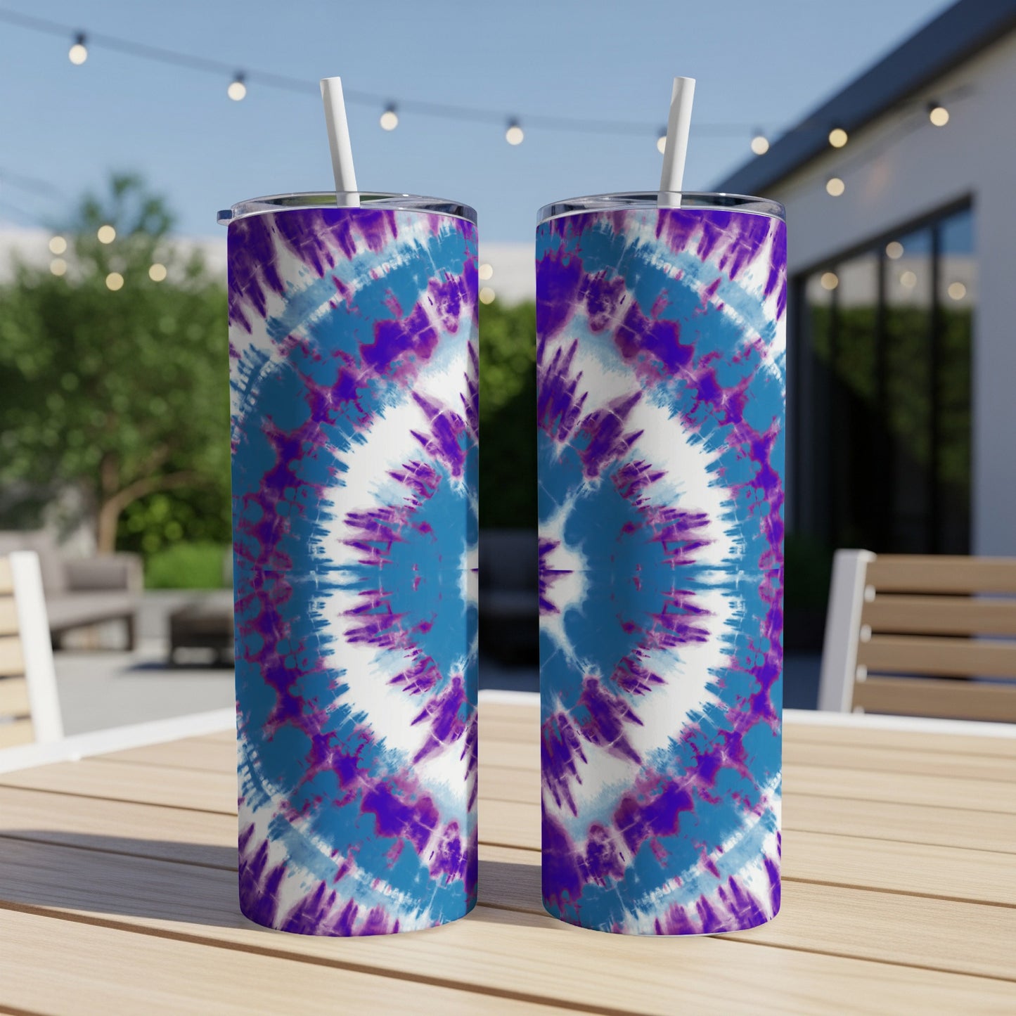 Two tumblers with blue and purple tie-dye pattern and white straws.