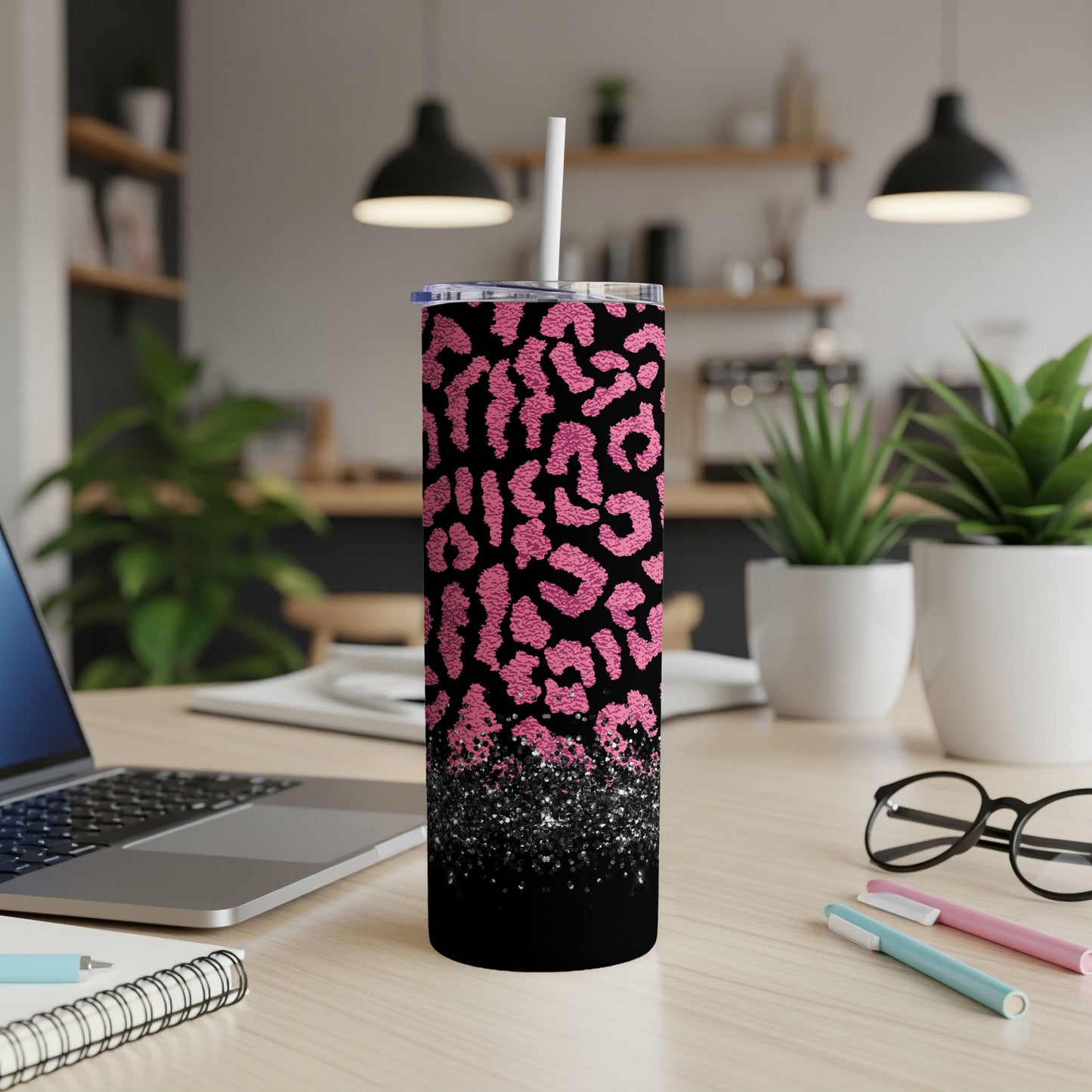Black tumbler with pink leopard print and glitter accents.