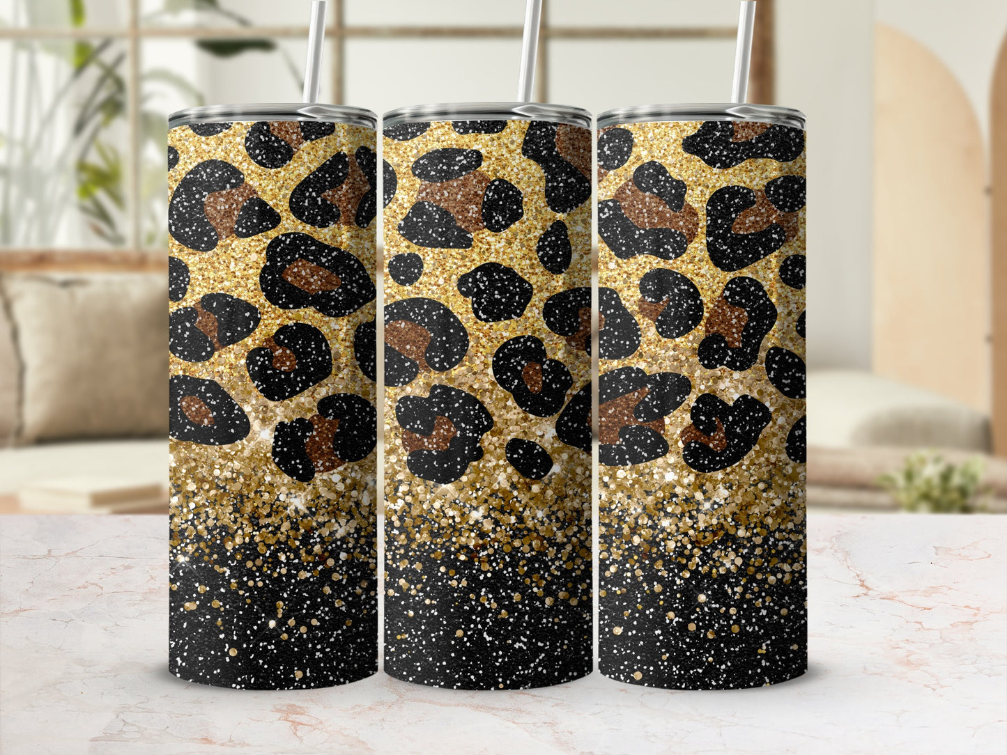 Three tumblers with leopard print and gold glitter accents.