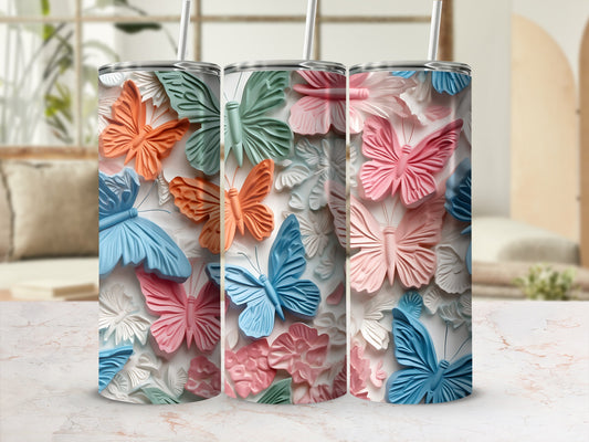 Three tumblers with embossed butterflies and flowers in pink, blue, and orange.