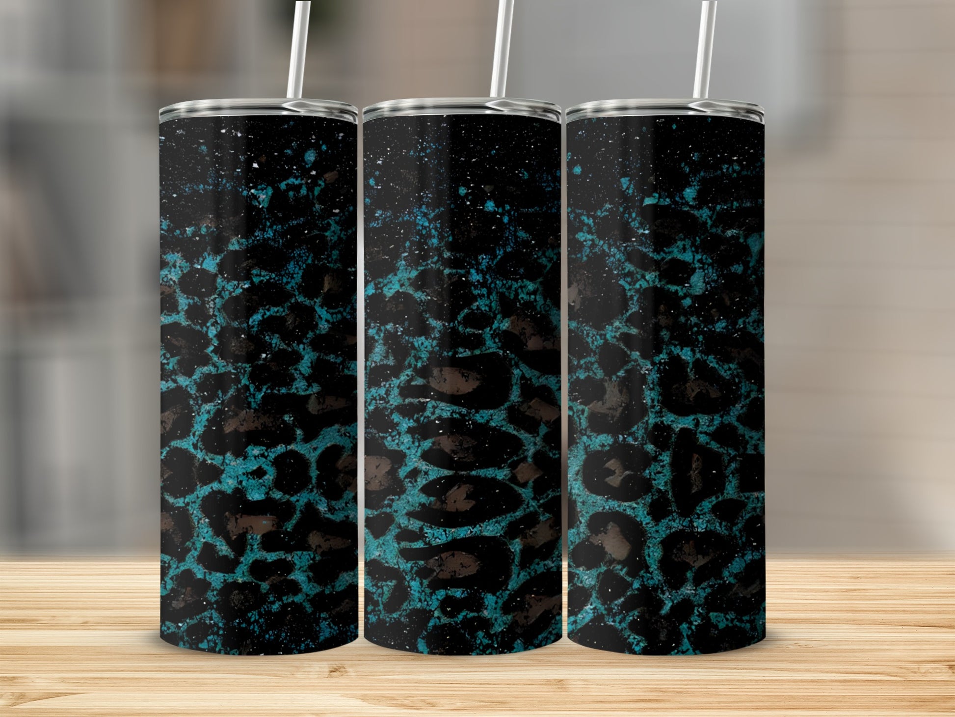 Trio of tumblers with teal and black leopard print and speckles.