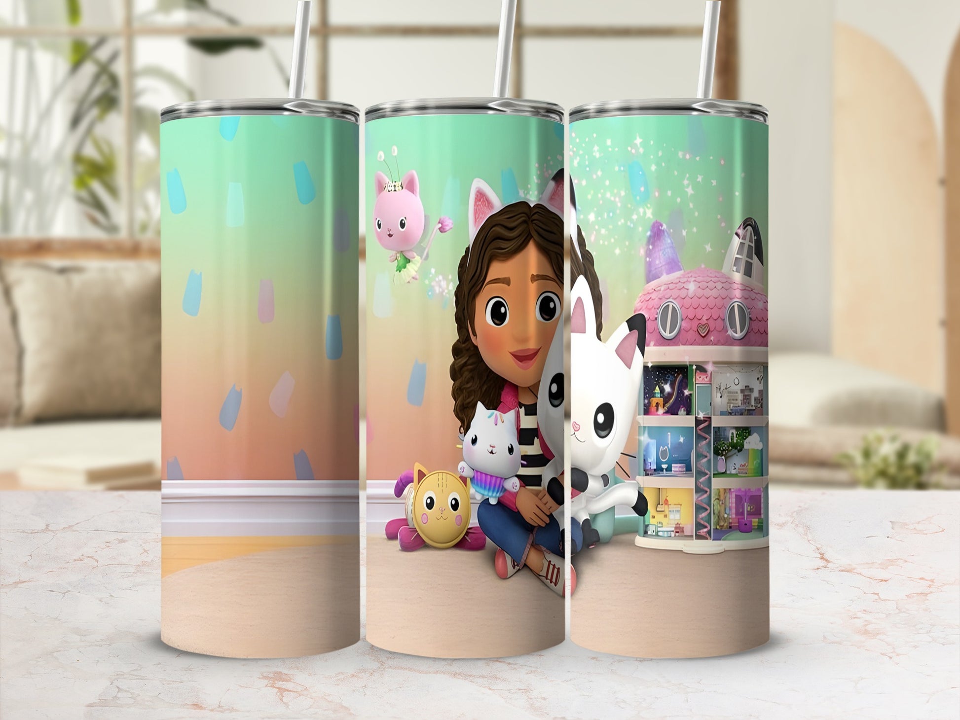 Gabby's Dollhouse characters on a colorful patterned tumbler with a straw.