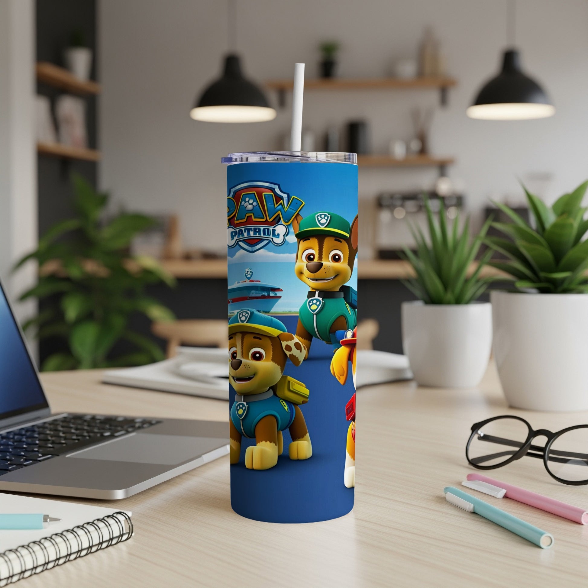 Paw Patrol characters Chase and Marshall on a blue tumbler with a straw.
