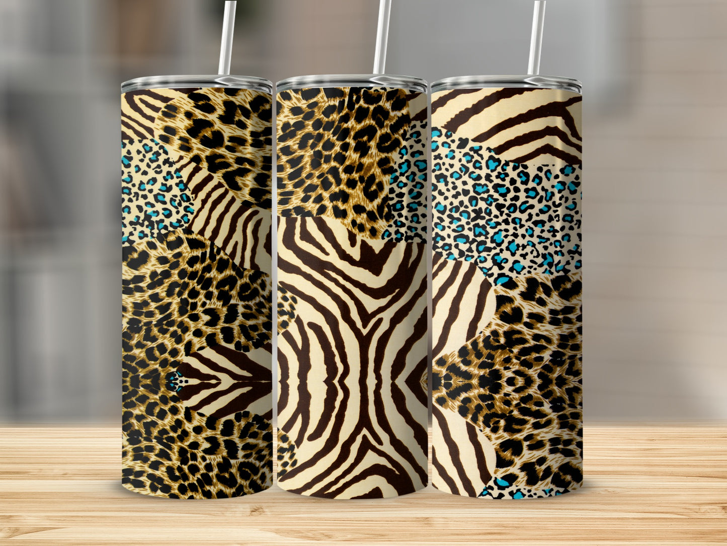 Three tall tumblers with mixed animal print designs, including leopard and zebra.