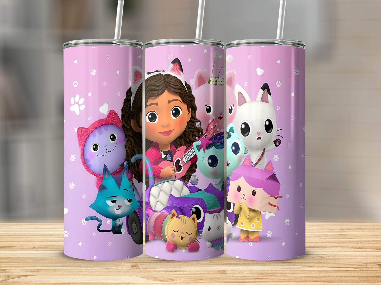 Three purple tumblers with Gabby's Dollhouse characters and paw prints.