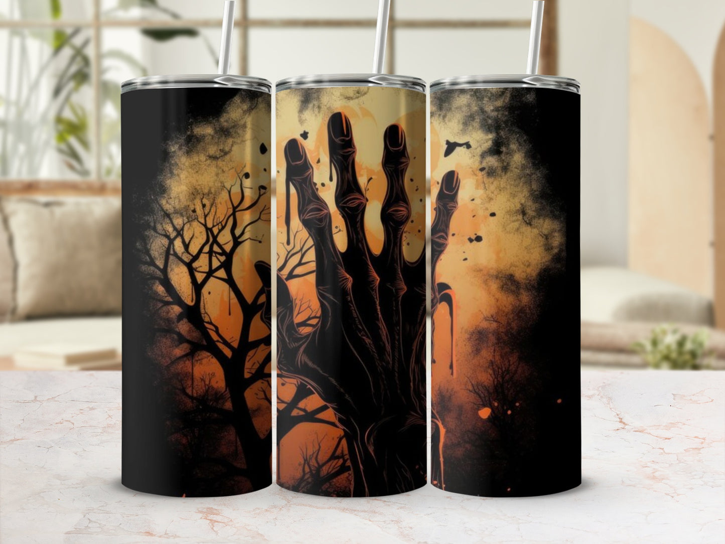 Three tumblers with Halloween themed designs featuring a spooky hand and bare trees.