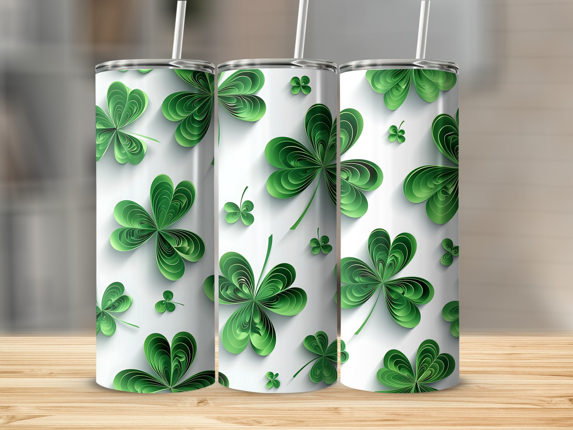 Three white tumblers decorated with green paper shamrocks and subtle shadows.