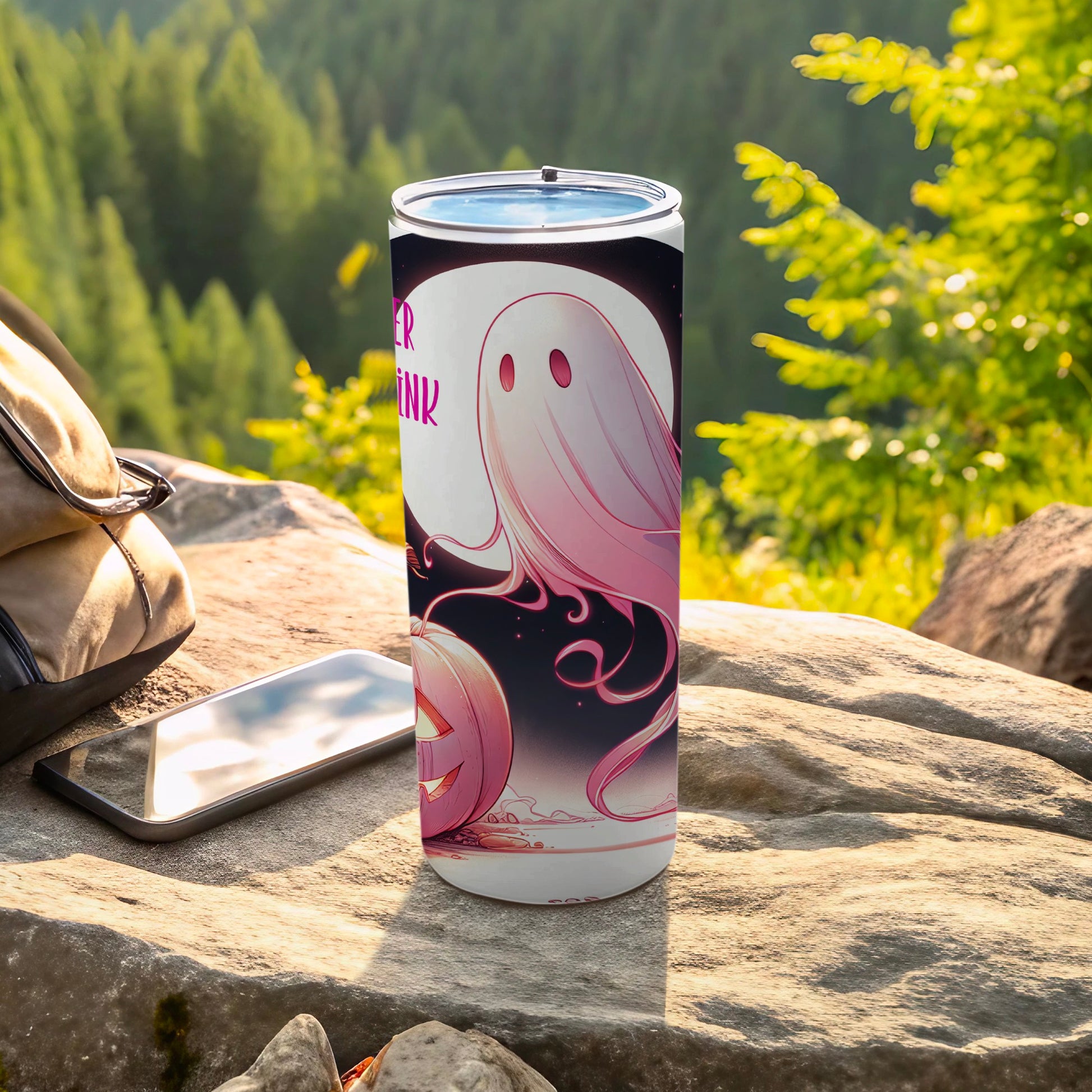White tumbler with pink ghost and jack-o'-lantern Halloween design.