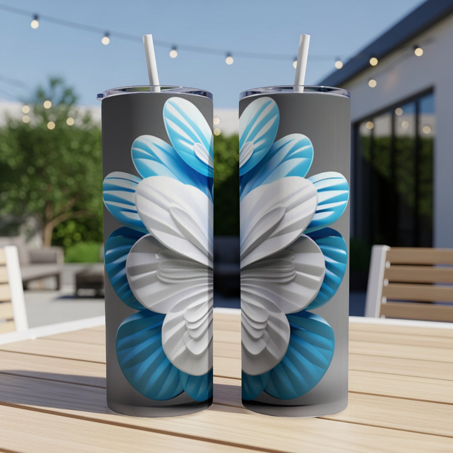 Two tumblers with a blue and white layered flower design on a table.