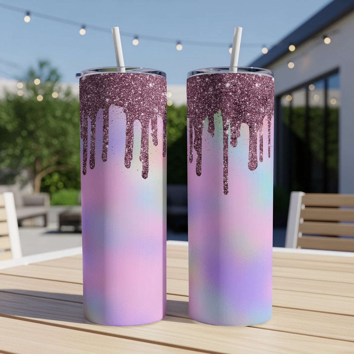 Two tumblers with glitter drip design and pastel ombre, set on a wooden table.