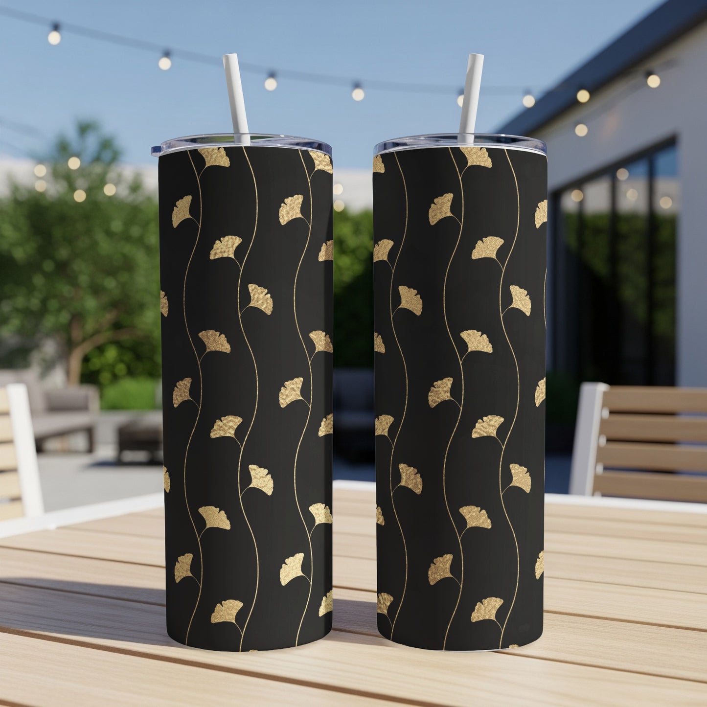 Two tumblers with a black background and gold ginkgo leaf pattern.