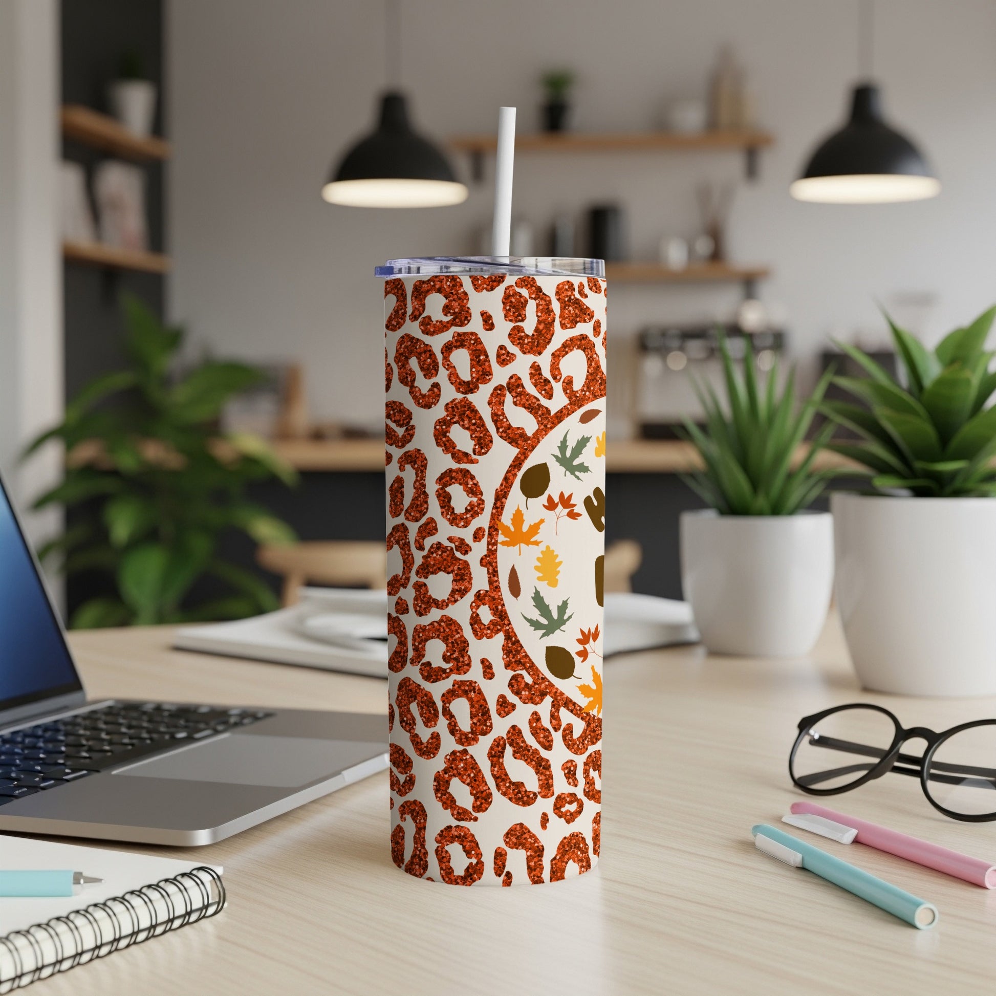 White tumbler with leopard print and autumn leaves design.