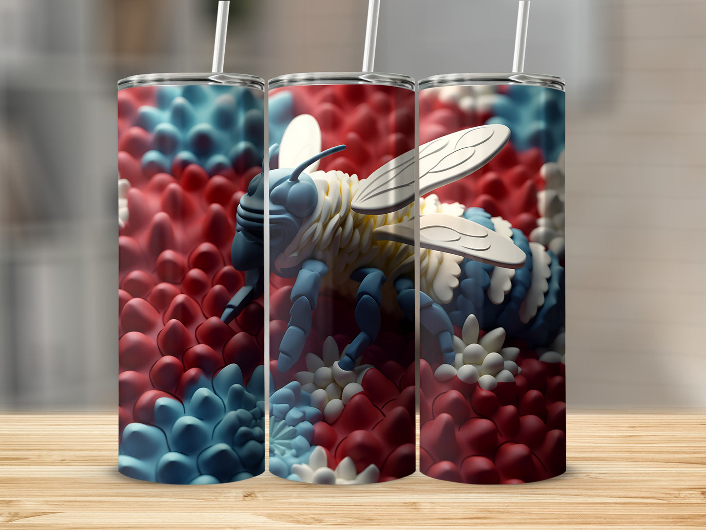 Three tumblers with a blue and white bumblebee and red and blue petal pattern.