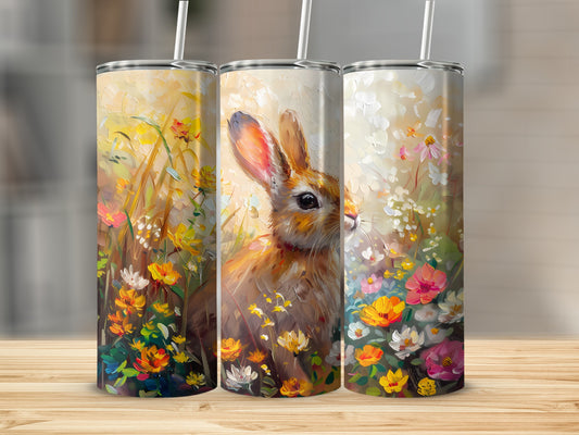 Bunny among colorful wildflowers, with straw in top of tumbler.