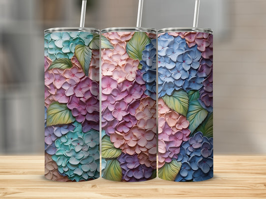 Three tumblers with embossed hydrangea floral patterns in blue, pink, and teal.