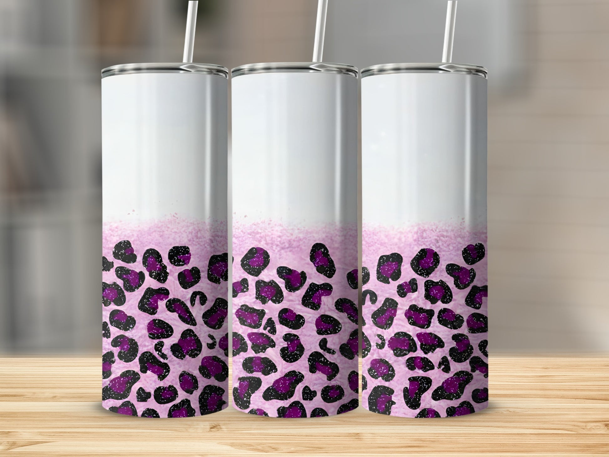 Three white tumblers with purple leopard print and glitter accents.