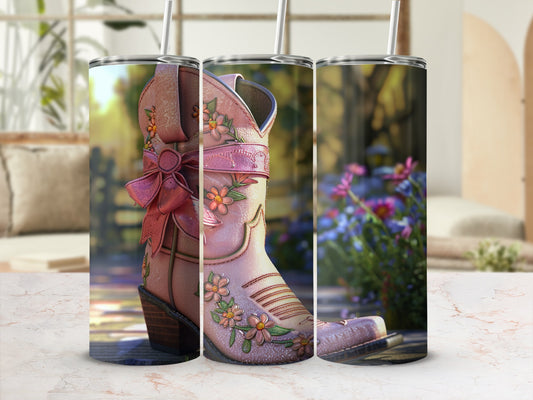 Pink cowboy boot tumbler with floral embroidery and pink bow.